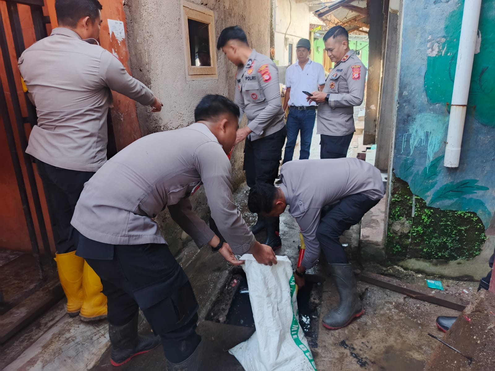 Polisi Sigap Bantu Warga Bersihkan Material Sisa Banjir